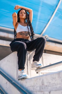 Young black woman with long braids and tattoos