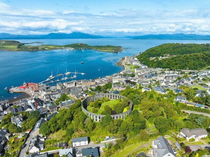 Aerial view of the harbour town of Oban with McCaig's Tower