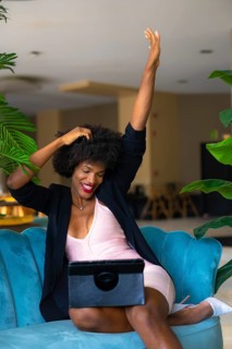 Young entrepreneur of black race and afro hair making a video call very happy