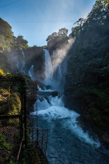 Flashes of the sun at dawn inside the Pulhapanzak waterfall on Lake Yojoa. Honduras