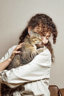 A devoted and gentle cat hugs his happy owner