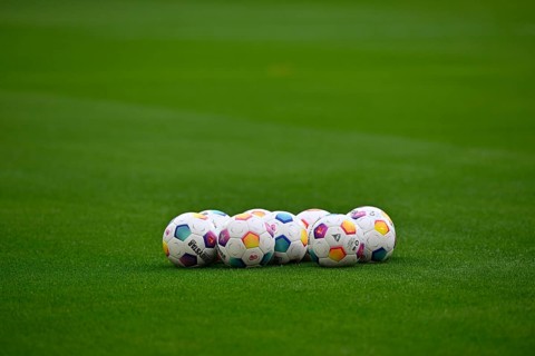 Adidas Derbystar match balls lie on grass