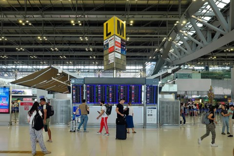 People in front of departure board