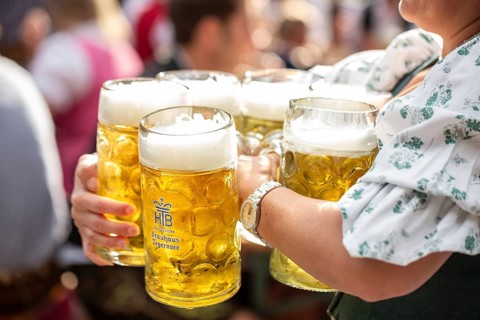 Waiter with beer mugs