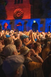 Cheering crowd at Live Klostersommer Festival in Historic Monastery