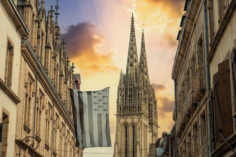 Sunset in the medieval village of Quimper and the Saint Corentin de Quimper Cathedral in the background in the department of Finisterre. French Brittany
