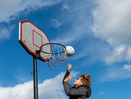 Basketball jumping with the ball to the basket and net