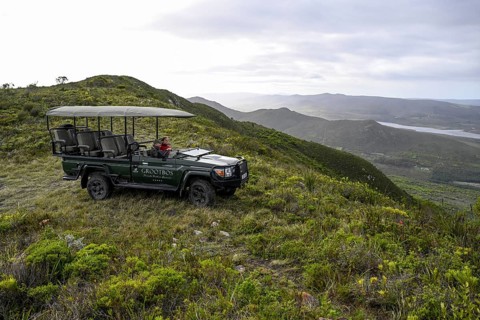 Pickup truck with tourists on a flower safari