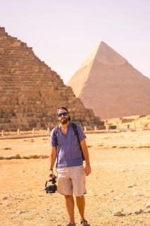 A young photographer at the pyramid of Cheops the largest pyramid. The pyramids of Giza the oldest funerary monument in the world. In the city of Cairo