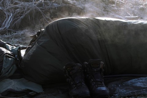 A sleeping bag steams in the morning sun after a frosty night