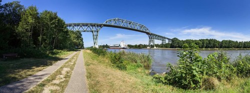 Kiel Canal with Hochdonn railway bridge and container ship