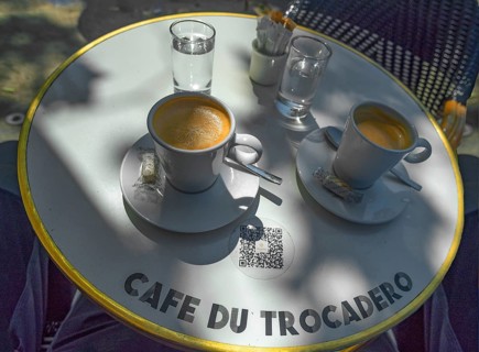 Two espressos on a bistro table in a cafe