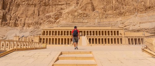 A young woman visiting the Mortuary Temple of Hatshepsut without people on her return from tourism in Luxor after the coronavirua pandemic