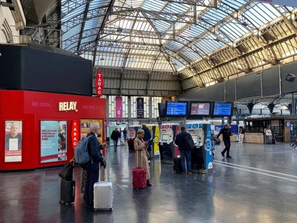 Travellers waiting in front of ticket counter