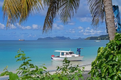 Small fishing boat anchored before Paradise Beach on Carriacou