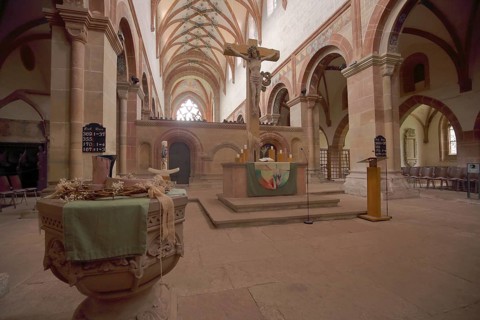 Interior view with baptismal font and crucifix of the monastery church and former Cistercian abbey
