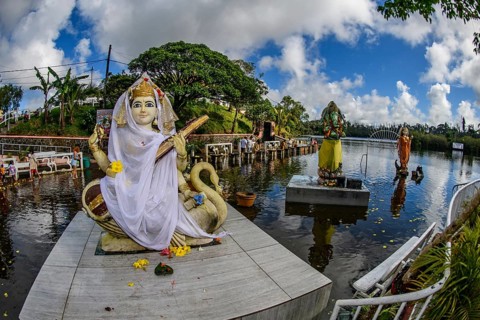 Left Goddess of Wisdom Sarasvati Saraswati Maa Wife Consort of Lord Brahma middle God Deity in Elephant Shape Shape of Elephant Elephant God Ganesha right background Goddess Deity Parvati Wife Consort...