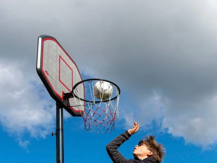 Basketball jumping with the ball to the basket and net