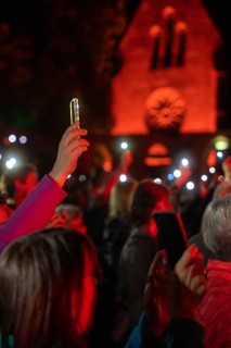 Crowd with mobile phone lights at Live Klostersommer Festival in Historic Monastery