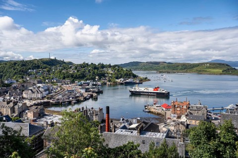 View over the harbour town of Oban to the ferry harbour with the ferry Isle of Lewis operating between Oban and Isle of Barra