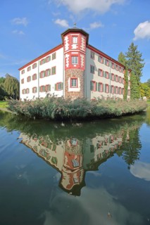 Moated castle built 16th century with reflection in the pond