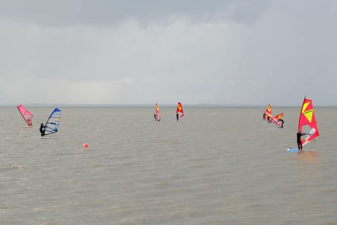 Surfers of a surf school on the sea