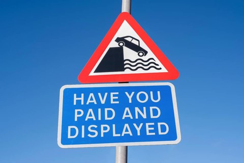 Traffic warning sign with pictogram Attention shore and English language sign for redeeming and visibly displaying a parking ticket