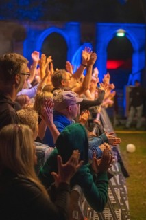 Cheering crowd at Live Klostersommer Festival in Historic Monastery