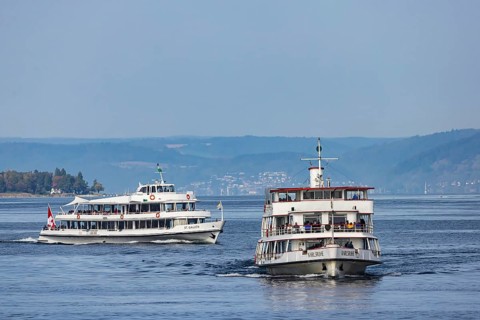 The excursion boats ST. GALLEN and KARLSRUHE underway on Lake Constance against the backdrop of Birnau Abbey