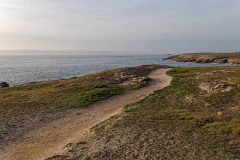 Hiking trail on the Cote Sauvage. The Wild Coast is a rocky coast on the west side of the Quiberon Peninsula in Brittany. Cores
