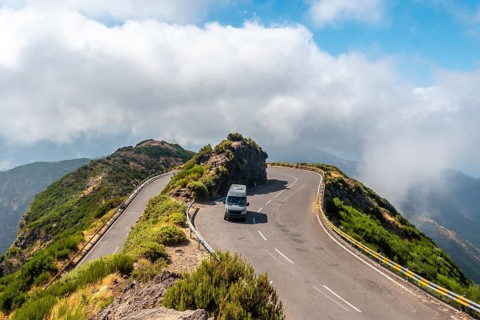 A van cornering at the Miradouro Lombo do Mouro