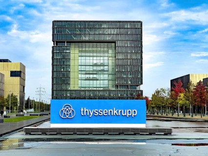 View of headquarters in the background in the form of cube of steel giant company of steel production manufacturer of steel thyssenkrupp Thyssen Krupp in the foreground logo and lettering