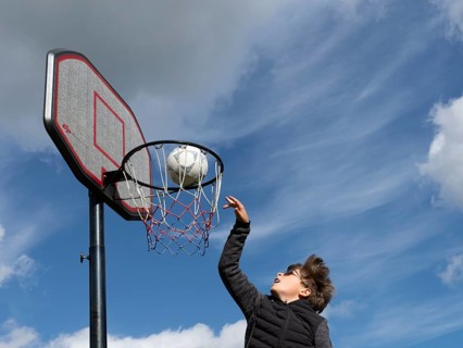 Basketball jumping with the ball to the basket and net