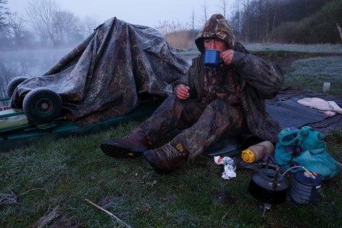 Man drinking a coffee in nature at sub-zero temperatures