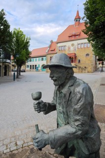 Stone mason fountain with sculpture and town hall