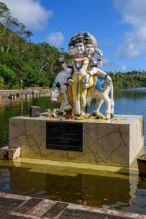 Hindu deity statue figure sculpture of god deity Dattatreya embodiment of trinity Brahma Vishnu Shiva at religious site largest Hindu sanctuary sanctuary for religion Hinduism outside of India for dev...