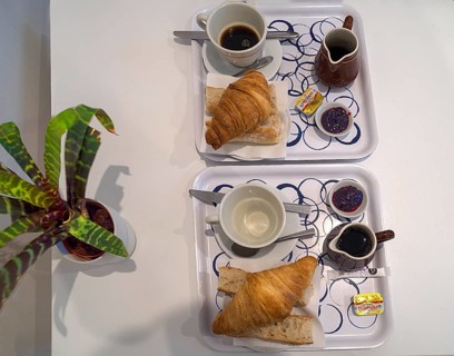 Typical French breakfast brioche and coffee in a budget hotel