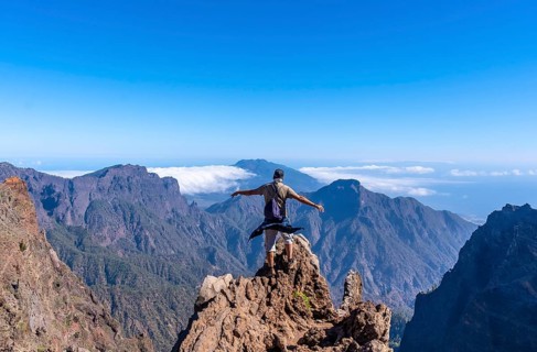 A young man after finishing the trek at the top of the volcano of Caldera de Taburiente near Roque de los Muchachos one summer afternoon
