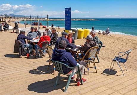 Group of men play dominoes at La Barceloneta beach