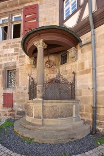 Historic draw well at the half-timbered house Sektkellerei Kessler
