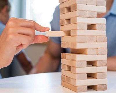 Close up family playing jenga together