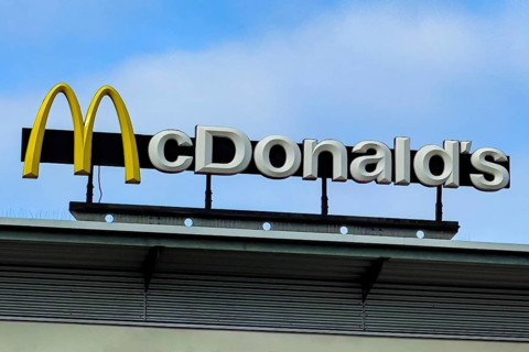 Logo yellow M in with lettering McDonald's above fast food restaurant
