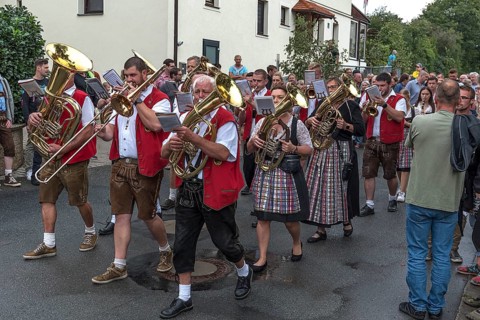 Brass band marches through the village on the day of the traditional Tanzlindenfest