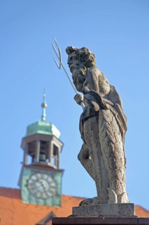 Sculpture Neptune with trident and spire of the town hall