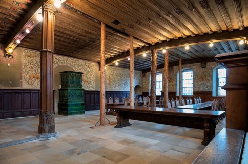 Interior view of winter refectory with tiled stove