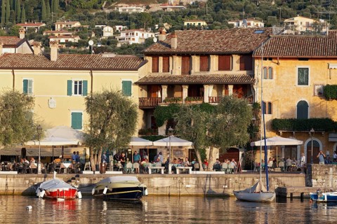 Lake shore with terrace restaurants and old town houses