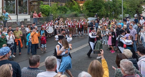 Dance of the Kirchweih couples with brass band on the street on the day of the traditional Tanzlindenfest
