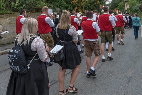 Brass band marches through the village on the day of the traditional Tanzlindenfest