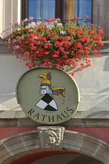 Town coat of arms with floral decoration on the town hall