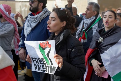 Woman holding sign Free Palestine